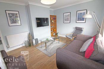 Large Lounge with large LED Smart wall mounted TV, Sofa & Chair, recliner and other lounge furniture. A welcoming homely space for relaxing and socialising