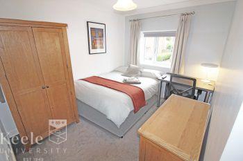 Bedroom 2 - A large double bedroom with a double divan bed, wall mounted LED Tv, bedroom furniture (wardrobes / drawers/dresser / desk + study chair)